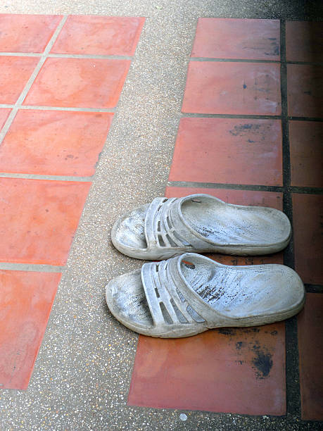 istock Old sandal on brick ground 496959750