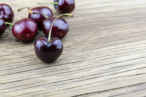 istock fresh cherries on wooden table.Selective focus. 496960198