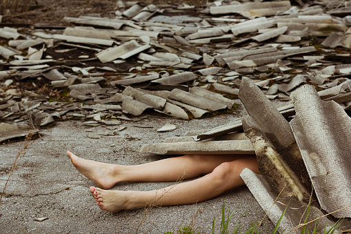 body of a young girl in the ruins of the building