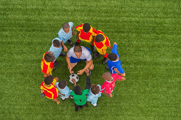 istock Young Footballers With Their Coach 496969353
