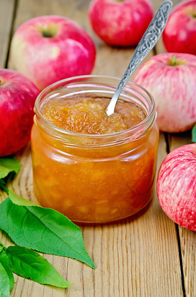 Jam apple with apples and spoon on the board