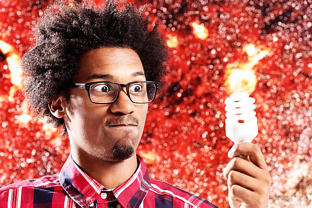 istock Young scientist tries to light energy-saving bulb with his mind! 496972165