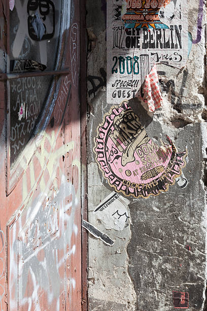 istock Graffiti and posters on house wall in Berlin 496972443