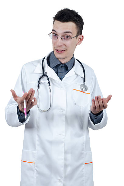 Young male doctor with glasses. Isolated on white Young male doctor with glasses gesturing and looking at the camera. Isolated on white dissert stock pictures, royalty-free photos & images