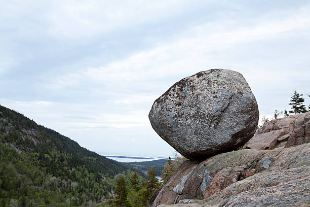 Bubble Rock is arguably the most well-known rock in the entire state of Maine and one of the most visited spots in Acadia National Park. Perched precariously on the eastern edge of the summit of South Bubble, the giant boulder is an excellent example of a glacial erratic, a huge rock that was moved here by the powerful action of ancient glaciers.