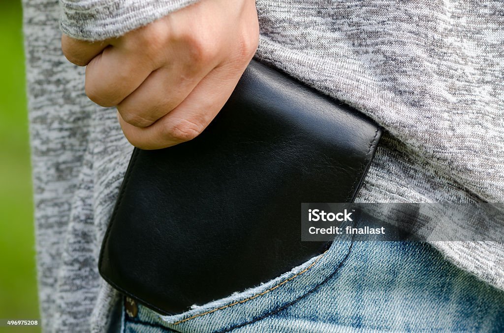 Woman pulling out her wallet from the pocket 2015 Stock Photo