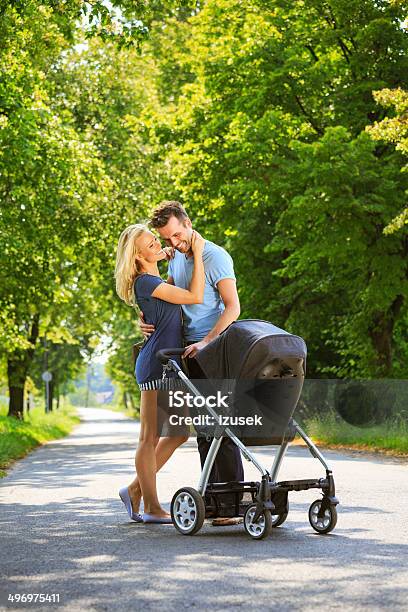 Happy Couple In A Park Stock Photo - Download Image Now - Baby Stroller, Adult, Baby - Human Age