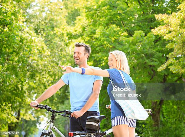 Happy Couple In A Park Stock Photo - Download Image Now - Adult, Adults Only, Bicycle