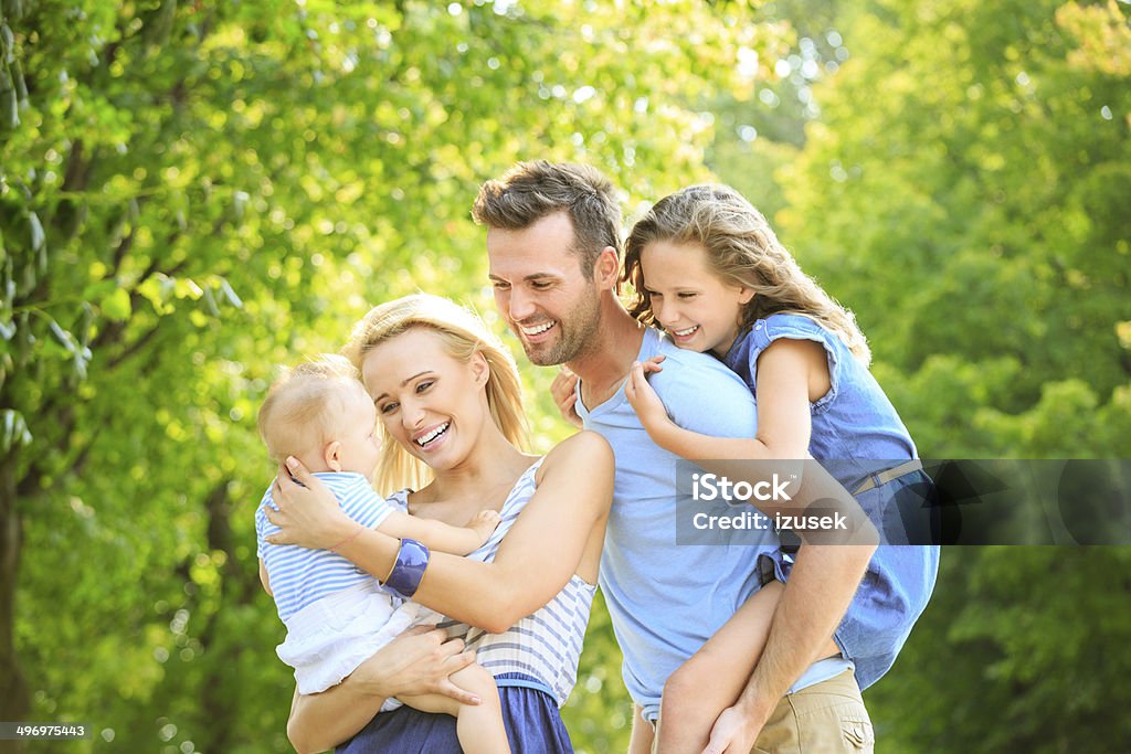Happy family Outdoor portrait of happy parents with their children.  6-11 Months Stock Photo