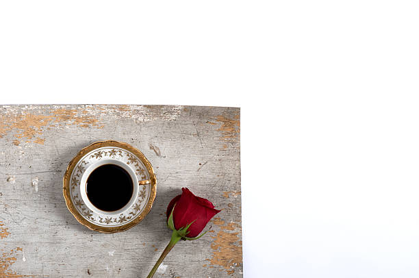 istock cup of coffee with rose over old gray table 496977160
