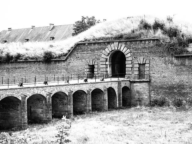 Entrance gate and bridge to the fortificated town Terezin, Czech Republic. Black and white image.