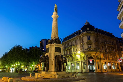 Chambery, Rhône-Alpes, france - August 12, 2015: Fontaine des Éléphants in Chambéry in France. It was built in 1838 to honour Benoît de Boigne's. The fountain has realistic sculptures of the head and forelimbs of four lifesize elephants truncated into the base of a tall column.