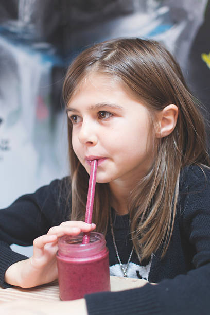 istock Girl drinking a smoothie 496977912