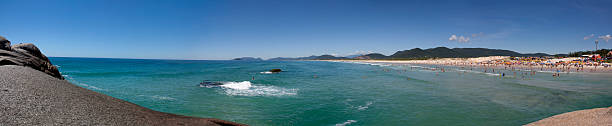Joaquina beach panoramic view Florianopolis, Santa Catarina, Brazil - January 18, 2010: Panoramic view of a Brazilian beach called Joaquina located in Florianopolis city in Santa Catarina state with many tourists enjoying the clear sky and sunny day on it. joaquina beach in florianopolis santa catarina brazil stock pictures, royalty-free photos & images