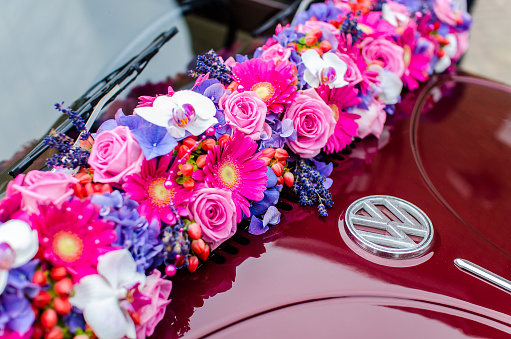 Elspeet, The Netherlands - August 19, 2015. Bride flowers on a Volkswagen Beetle at a wedding in Elspeet, The Netherlands. 