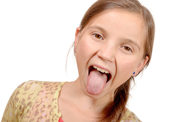 istock little girl puts out her tongue 496983530