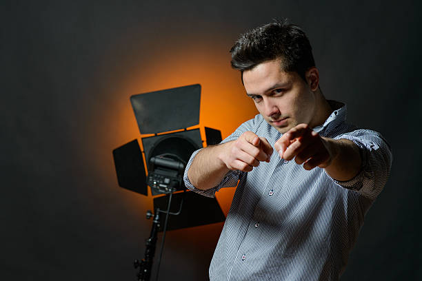 istock Beautiful male model posing at studio in the light flashes 496983632