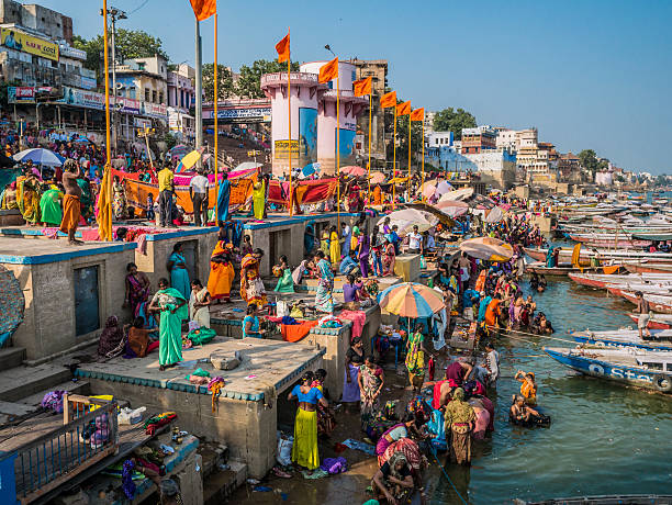 Varanasi India Varanasi, India - October 05, 2015: Pilgrims in Dashashwamedh Gha at the Ganges river in Varanasi . This is one of the oldest inhabited cities in the world and also the holiest of the seven sacred cities in Hinduism and Jainism and so the most important pilgrimage place for hindus. Many ghats, embankments made in steps, are placed in one of the river sides and it is where pilgrims perform ritual ablutions. varanasi stock pictures, royalty-free photos & images