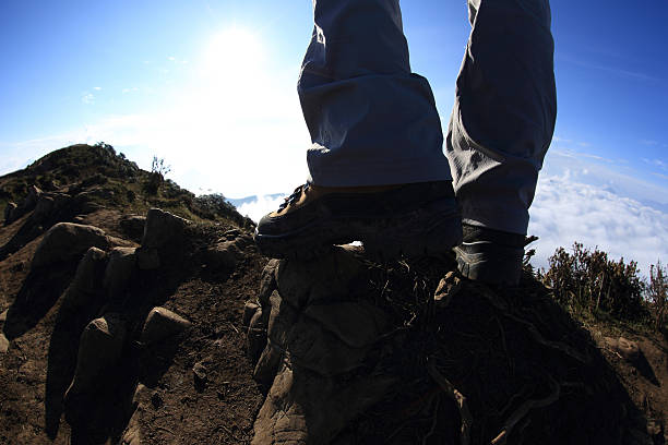 Black leather hiking boots on a black rubber mat