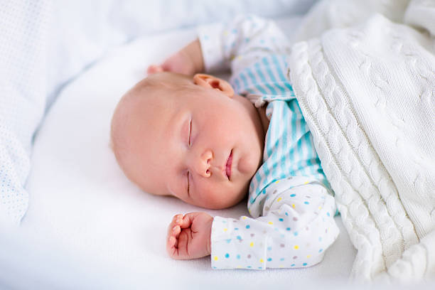 istock Cute newborn baby in white bed 496988290
