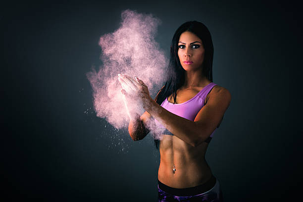 istock Athletic young woman clapping hands with powder 496988582