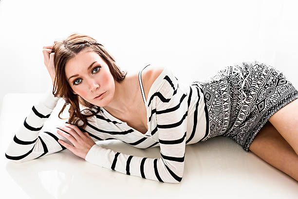 istock Sensual young fashion model lying on table 496989370