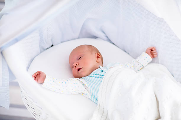 istock Cute newborn baby in white bed 496989420