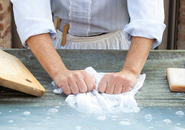 Woman washing clothes by hand, old stule.