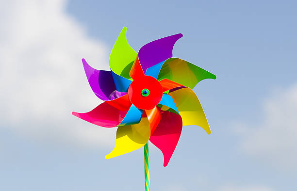 istock Childish pinwheel against blue sky background. 496989947