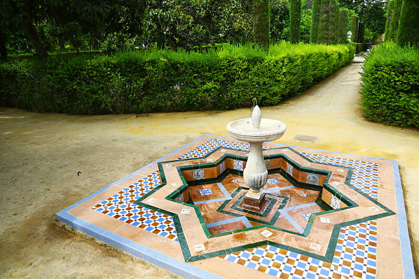 Fountain in gardens of Reales Alcazares, Sevilla Arab fountain in the gardens of Reales Alcazares, Sevilla alcazares reales of sevilla stock pictures, royalty-free photos & images