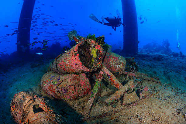 istock SCUBA diver swims past rusting metal pipes under an oilrig 496992389