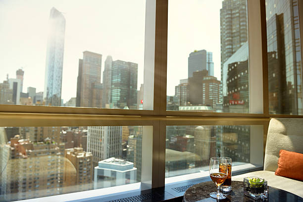 Cocktail and Beer, Manhattan, NYC. Window inside a cafe. On the table there are two cocktails. Out of the window there is a panoramic view of Upper Midtown Manhattan, NYC, USA hotel window view stock pictures, royalty-free photos & images