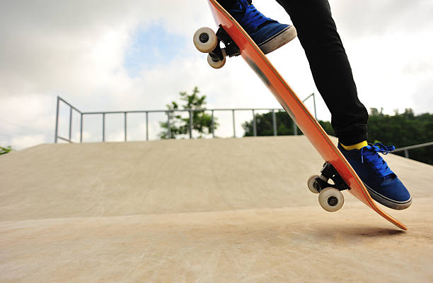 istock skateboarder jump at skatepark 496995275