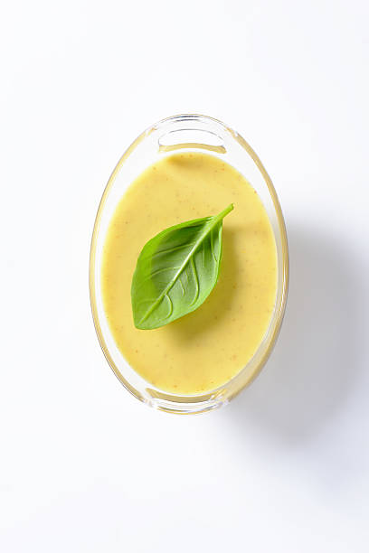 spicy yellow sauce bowl of spicy yellow sauce isolated on white background hollandaise sauce stock pictures, royalty-free photos & images