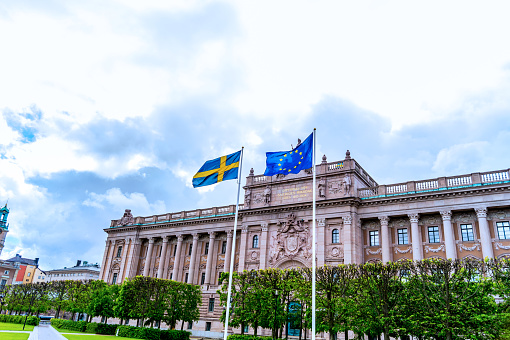 Swedish and EU flags in front of swedish parliament