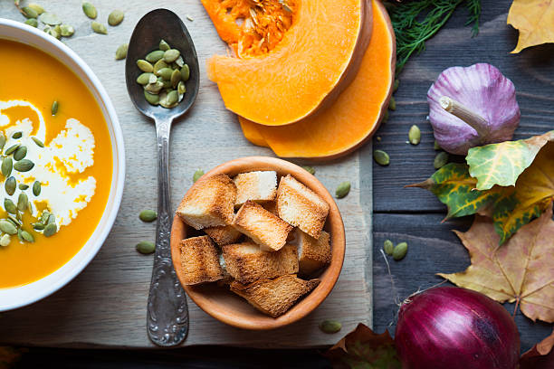 istock Pumpkin soup on a wooden table 496997552