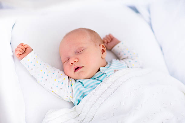 istock Cute newborn baby in white bed 496997564