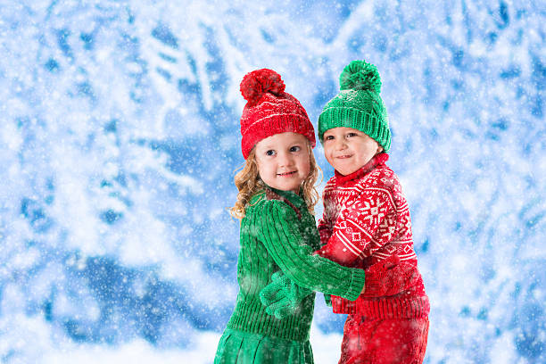 istock Kids playing in snowy winter forest 496998986
