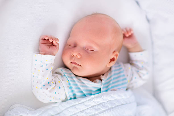 istock Cute newborn baby in white bed 496999260