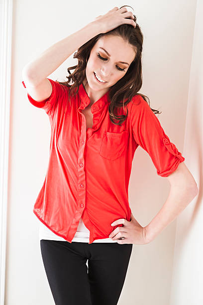 istock Beautiful young woman standing against wall 496999294
