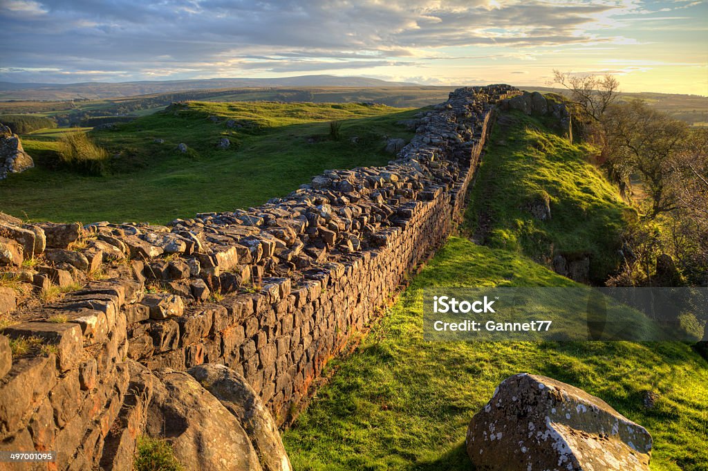 Evening Light on Hadrian's Wall A stretch of Hadrian's Wall at Walton's Crags in Northumberland, England, coloured by the setting sun Hadrians Wall Stock Photo
