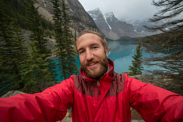 istock Young man at Moraine lake taking a selfie portrait 497001164