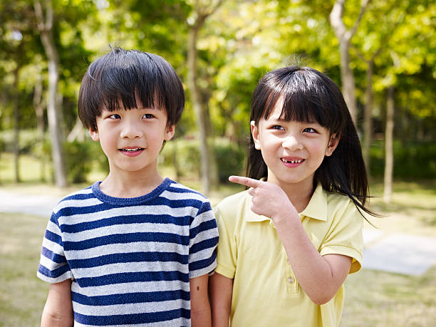 asian brother and sister looking cute and funny.