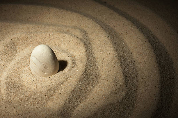 istock White stone sticking out of the sand 497001723