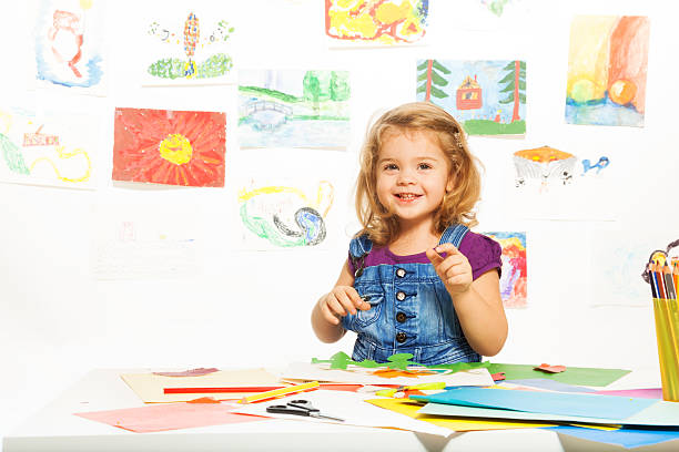 istock Smiling girl busy gluing 497001821