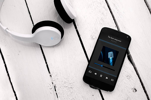 istock Modern smartphone on the wooden board with bluetooth headphones. 497002373