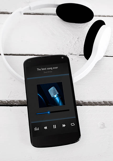 istock Modern smartphone on the wooden board with bluetooth headphones. 497002387