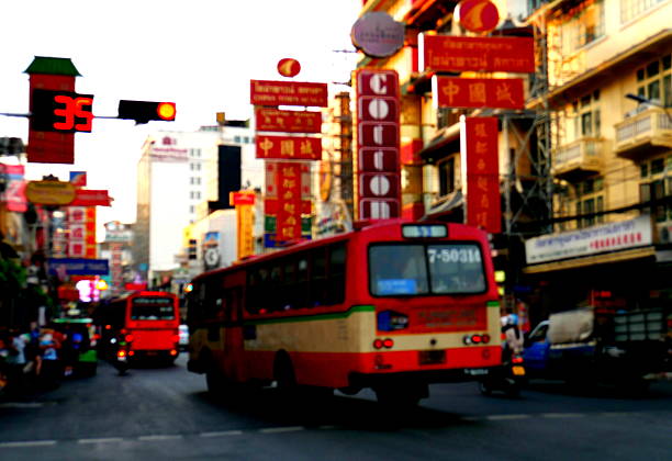 Bangkok, Thailand – November 6, 2015: View of China town in Bangkok. There are lots of shops, and food stalls on the sidewalk. People walk, eat and take photos around the area. Street vendors sell food on the sidewalk, some sell on the road. Yaowarat Road (China Town) is famous for its night life for dining and eating with lively environment.
