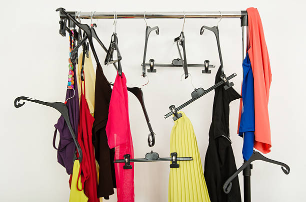 Messy rack of clothes and hangers. stock photo