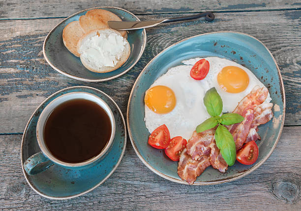 istock Fried eggs,  bacon, tomato, toast and a cup of coffee 497013324